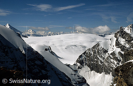 Foto: Blick von der Bütlasse über scharfe Gratkanten zum Petersgrat und auf den Kanderfirn. Im Hintergrund die Walliser Alpen mit Quellwolken. Aufnahme ab Dia.