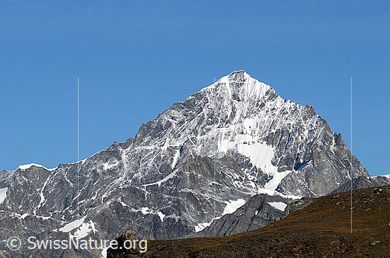 Foto: Dent Blanche und Pointe de Zinal.
Die Dent Blanche als mächtige Bergpyramide. Rechts vom Gipfel: ENE-Grat (Ostnordost-Grat, Viereselsgrat)
Links vom Gipfel: S-Grat (Südgrat, Normalroute)
Davor die Pointe de Zinal.