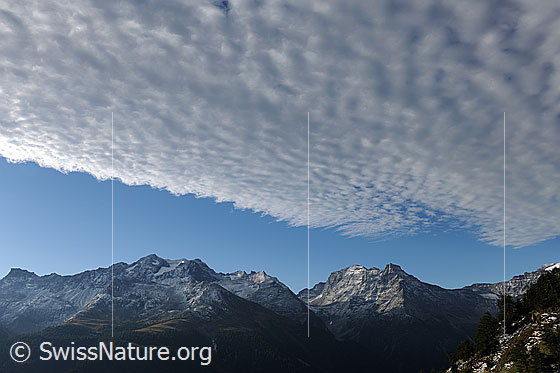 Foto: Morgenstimmung mit Wolkenband über Berglandschaft.